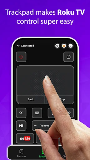 Hand using trackpad on mobile Roku TV remote with controls for Back, App, Volume, and quick YouTube access